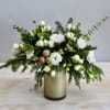 The &quot;Champagne Sparkle Holiday Arrangement&quot; exudes elegance and festivity, blending ivory and