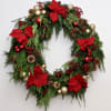 Decked out for the holidays, this wreath of fir, poinsettias and ornaments