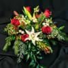 Luxurious red roses and ball ornaments with seasonal flowers create an exquisite