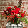 Compilation of red seasonal blossoms paired with red winter berries and mixed