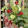 Tall arrangement filled with roses and hydrangeas, perfect for that hard to