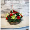 round and low centerpiece with one candle and xmas flowers