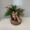 Flowering Christmas Cactus in a decorative container with a bow