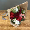 This bouquet will make anyone's holiday season merry! Bouquet will be hand