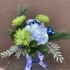 This striking arrangement of blue hydrangea, green Fugi mums, blue ornament balls