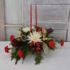 Various priced holiday centerpieces, featuring Christmas greens and holiday hued flowers, in
