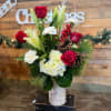 Winter Wonder is in a Birchwood wrapped vase, including lilies, roses, berries