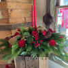 Our Red Christmas centerpiece includes, two candles, gold ribbon and ornaments, and