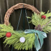 Stay inside where it&rsquo;s warm and create a cute grapevine evergreen wreath!