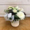 A petite arrangement of white spray roses, a white cremon crysanthemum, white
