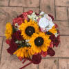 This bouquet pairs the cheerful brilliance of sunflowers with the deep passion