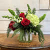 Red roses, green hydrangea, white snapdragons, bells of Ireland, white hypericum berries
