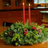This traditional centerpiece arrangement combines a delightful blend of fresh noble fir