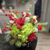 A beautiful green, red and white simply adorable Christmas Arrangement adding to