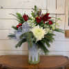Red roses, burgundy lily, white orchids, white chrysanthemums, green buttons, bells of