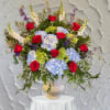 This one-sided Pedestal Arrangement is made with Roses, Hydrangeas, Snap Dragons &amp;