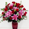 A masterwork of floral design featuring premium red roses and blush pink