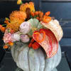 Fresh carved pumpkin arrangement with exotic twist.  It is arranged with