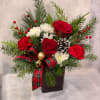 This delightful bouquet of Christmas roses and carnations are arranged in a