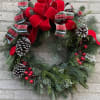 A custom designed fresh wreath, perfect for a front entrance door, fence