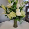 A beautiful mix of white flowers with touches of green berries and