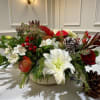 A contemporary winter arrangement designed with soft seasonal blooms and natural textural