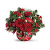 This festive bouquet includes red roses, red miniature carnations, variegated holly, noble