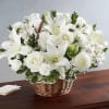 A natural wicker basket is filled with serene selection of white beautiful