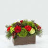 This is a festive holiday floral arrangement displayed in a rectangular rustic