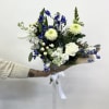 A burst of blue and white blooms with lush greenery, ready to