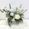 Seasonal blooms in vibrant blues and whites create an organic, elegant arrangement