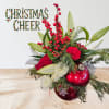 A cute, adorable arrangement in a Christmas ornament! Flowers will vary! We