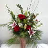 This beautiful design has roses, lilies, stock and lush holiday greenery that