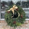 This wreath features Douglas Fir and Cedar, pine cones, and berries. It's