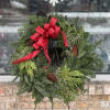 This wreath features Douglas Fir and Cedar, pine cones, and berries. It's