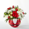 Seasonal flowers and greenery are designed in a ceramic nutcracker! 