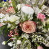Beautifully designed holiday centerpiece with holiday themed florals and greenery adorned with