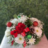 Lovely centerpiece ready to spread some holiday cheer. the centerpiece contains red