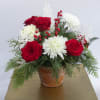  A wintery mix of pinecones, snowflakes, berries, white cushions, red roses