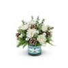 A lovely Christmas arrangement of white, silver and blue including Holiday greens