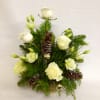 A Ceramic Container Filled With Assorted Pine, White Flowers, Gold Accents and