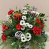A beautiful holiday arrangement in a black and white galvanized tin