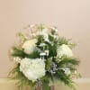A natural wood farmhouse container filled with evergreens and white hydrangea and