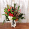 Mix of red and white florals with mixed greenery and pinecones in