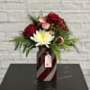 Bright and cheerful bouquet in Christmas reds, greens and whites - with