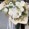A luxurious winter-inspired bouquet featuring premium white amaryllis, garden roses, cotton, and