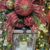 Beautiful Christmas lantern with black tin roof top.  Adorned with a