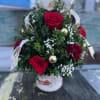 Beautifully decorated boxwood tree with red roses and carnations designed in a