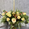 A chic mix of champagne-toned spray roses, holiday greens, and shimmering gold