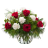 Roses, carnations and berries accented with evergreen are combined to make a